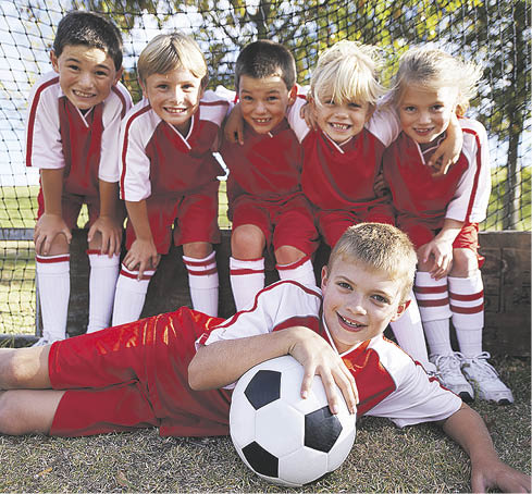 Portrait of a childrens soccer team posing for the team photo 